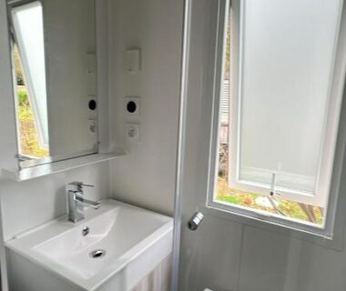 Salle de bain avec lavabo miroir et fenêtre dans le 404 mobil-home 3 chambres 2 sdb bassin d'Arcachon