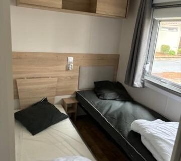 Chambre avec deux lits simples et rangements dans l'Amira 6-8 personnes
