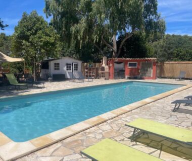 Piscine extérieure avec transats et petits bâtiments au camping Analaya