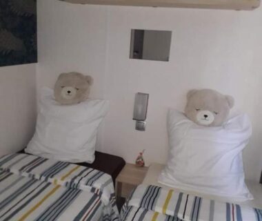 Chambre avec deux lits et peluches dans le logement familial d'Anne Marie