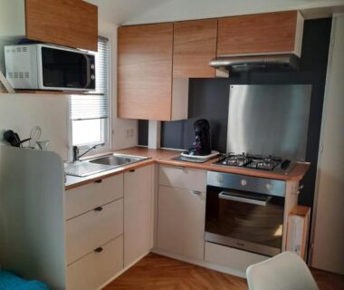 Intérieur avec coin cuisine équipé et micro-ondes dans l'hébergement du camping Aquapark -DESS