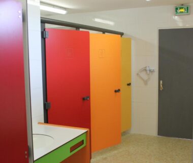 Bloc sanitaire avec cabines rouges orange et jaune au camping Aux Cygnes D'Opale