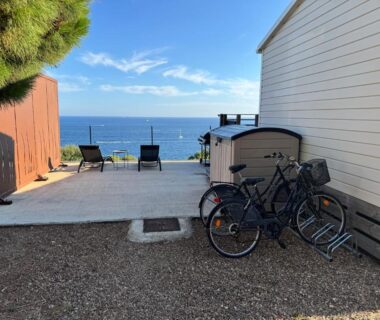 Terrasse avec chaises longues vélos et vue mer au Blue Horizon