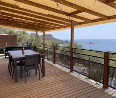 Terrasse couverte avec tables et vue mer au Blue Horizon