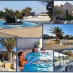 Piscine extérieure avec toboggan et terrasse au camping Bora Bora