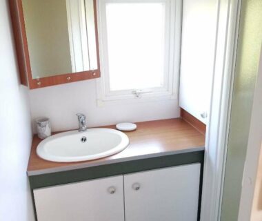 Salle de bain avec lavabo miroir et douche dans le Bungalow