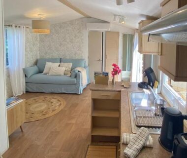 Intérieur avec kitchenette et coin salon dans le Bungalow Camping Parc Montana