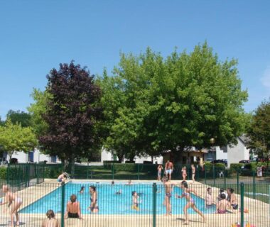 Piscine extérieure entourée d'arbres au camping Le Saillet Lestelle Betharram