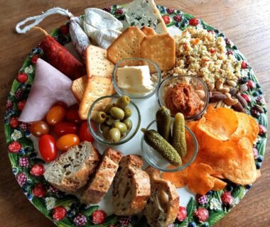 Table en bois avec plateau apéritif fromages charcuterie olives dans la Cabane Les Pourettes
