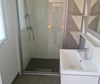 Salle de bain avec douche vitrée et lavabo dans le mobilhome premium 6 personnes au Camping 5 étoiles piscines chauffées