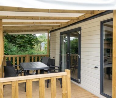 Terrasse couverte avec table et chaises sur mobil home du Camping Abijune d’Étretat