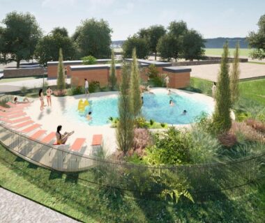 Espace aquatique extérieur circulaire avec transats et pelouse au Camping Canal de Berry
