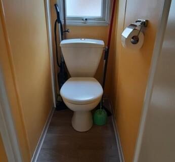 WC compact avec fenêtre et accessoires dans le locatif du Camping Domaine des iscles