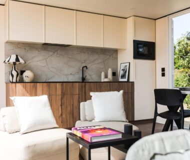 Coin salon avec kitchenette et baie vitrée donnant sur la terrasse au Camping Golfo Di Sogno