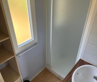 Salle d'eau avec douche et lavabo dans le Camping La sablière