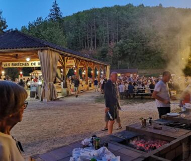Espace repas extérieur avec barbecues et kiosque éclairé au Camping Le Douzou