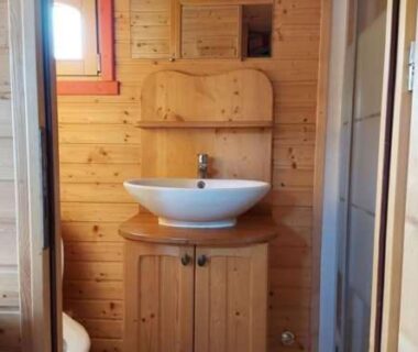 Salle d'eau en bois avec lavabo au Camping Le Sans Souci