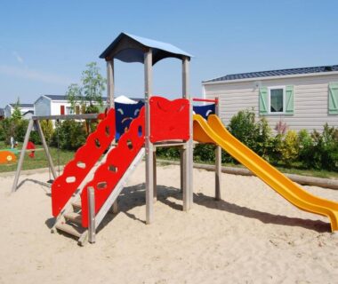 Aire de jeux avec toboggan et bac à sable dans le camping Le Walric
