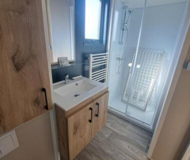 Salle de bain avec douche et lavabo au Camping Les 2 Plages