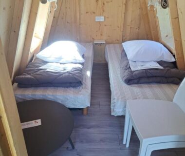 Intérieur cabine en bois avec deux lits au Camping Les 2 Plages