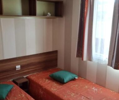 Chambre avec deux lits simples dans le mobil-home du Camping Oasis Village