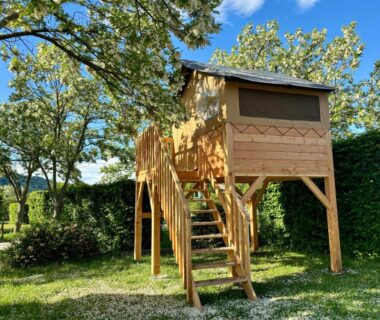 Cabane sur pilotis dans un emplacement ombragé au Camping Onlycamp la Rochette