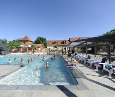 Piscine extérieure avec bassins baigneurs et transats au Camping Padimadour