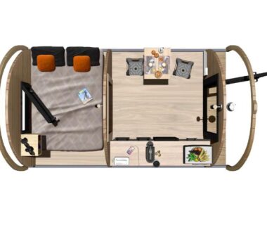 Intérieur de mobil-home avec lit et coin repas au Camping Padimadour