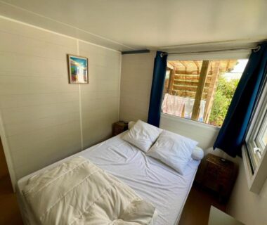 Intérieur chambre avec lit double et fenêtre du Camping Pedro mobilhome 4, 6 personnes