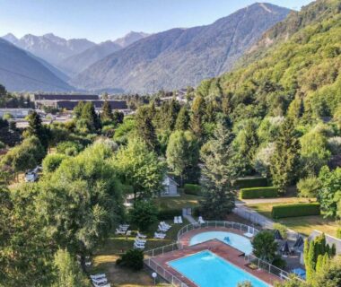Piscine extérieure entourée de montagnes au Camping Pradelongue