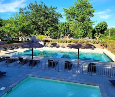 Piscine extérieure avec parasols et transats au Camping ZELAIA