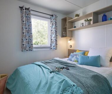 Chambre avec lit double et fenêtre au Camping de la Baie de Térénez