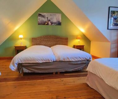 Chambre mansardée avec plusieurs lits et parquet au Camping et Gîte La Garenne de Moncourt Baie Somme