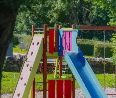 Aire de jeux avec toboggan et mur d'escalade au Camping l'Estela sur le GR70