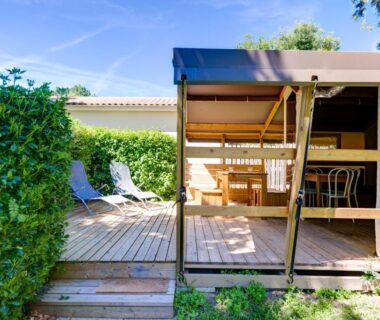 Terrasse en bois avec chaises et transats du Camping la Venise Verte