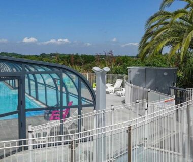 Piscine couverte et terrasse extérieure au Camping le Dolmen