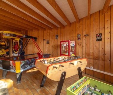 Salle de jeux intérieure avec baby foot et air hockey au Camping le Neptune