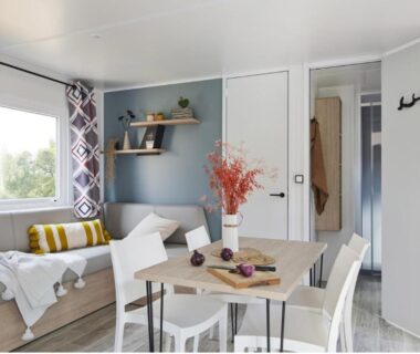 Séjour avec coin repas banquette et fenêtre du Camping le Rivage