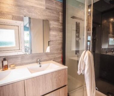 Salle de bain moderne avec douche et lavabo au Camping le Roucan West