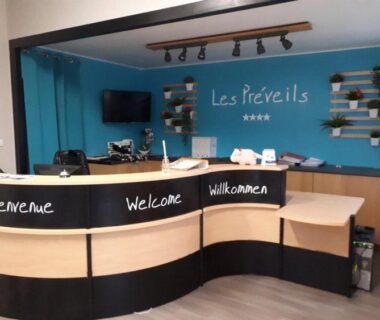 Réception avec comptoir et panneaux bienvenue au Camping maeva Club Les Préveils