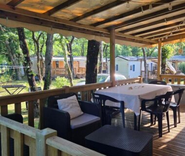Terrasse couverte avec table et salon du Cap'Océan Lodge