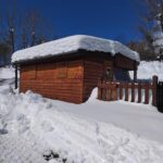 Façade en bois enneigée au camping d'Aussois Caravane 4 personnes au camping d'Aussois