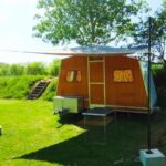 Emplacement herbeux avec caravane vintage dans le camping Caravane vintage