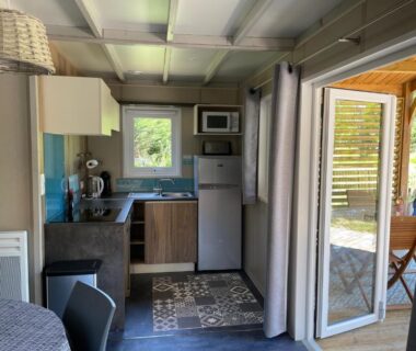 Intérieur kitchenette ouvert sur terrasse du Chalet au calme dans la pinède
