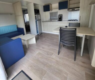 Intérieur avec kitchenette coin repas et canapé du Charmant mobil-home cosy 149