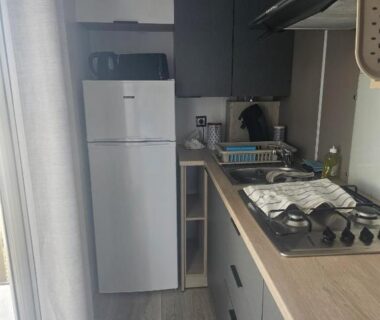 Coin cuisine avec réfrigérateur et plaques dans le Charmant mobil home premium L048
