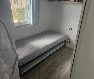 Chambre avec lit simple et fenêtre dans le Charmant mobil home premium L048