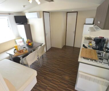 Intérieur avec salon et kitchenette du mobil home Entre plage et Landes Mobil home à Capbreton C LA VIEconciergerie