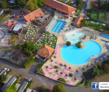 Vue aérienne du complexe aquatique avec piscine lagon et toboggans au camping Évasion Lodge