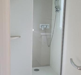 Salle de douche avec cabine et pommeau dans le FMLODGE mobil home le petit cocon